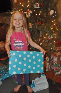 Kathryn used money from her piggy bank and shopped for Graham. She helped wrap the gift and she wrote his name and her name on the outside. She was so proud!